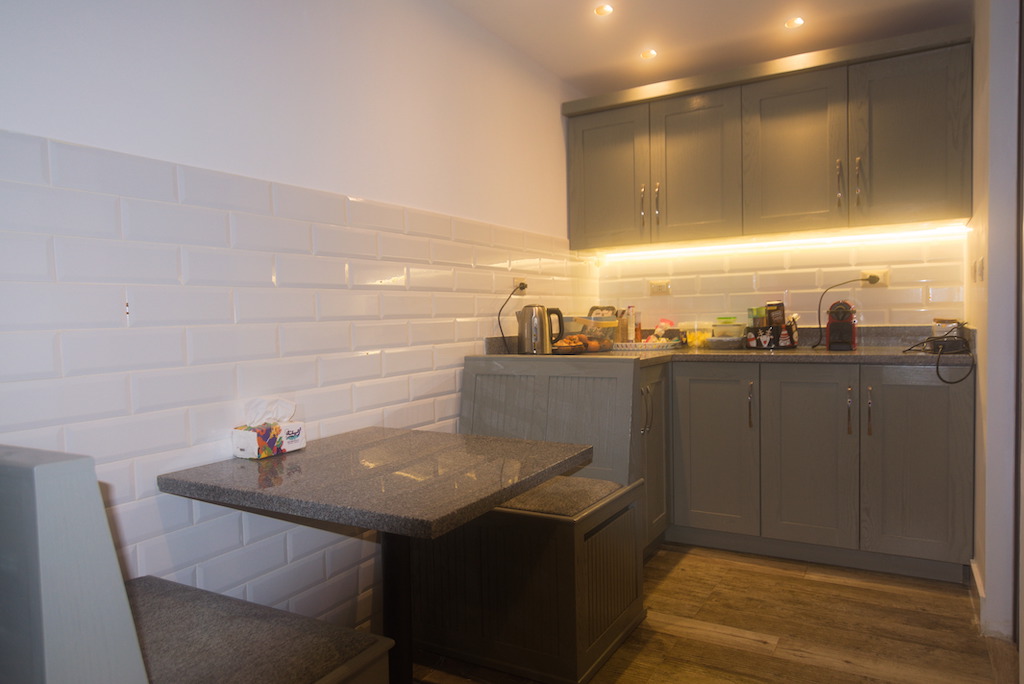 Extended kitchen design with modern finishes and neutral palette in Sodic Westown duplex renovation