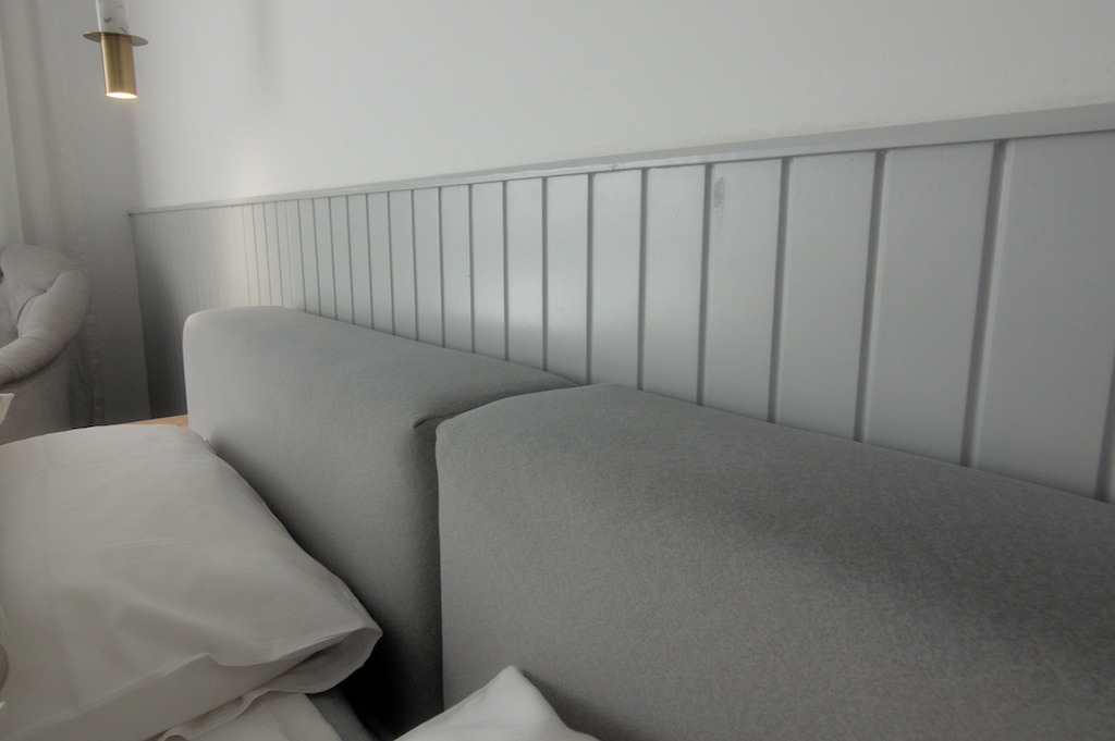 Master bedroom with soft neutral tones, minimalist furniture, and layered textures in Sodic Westown duplex renovation