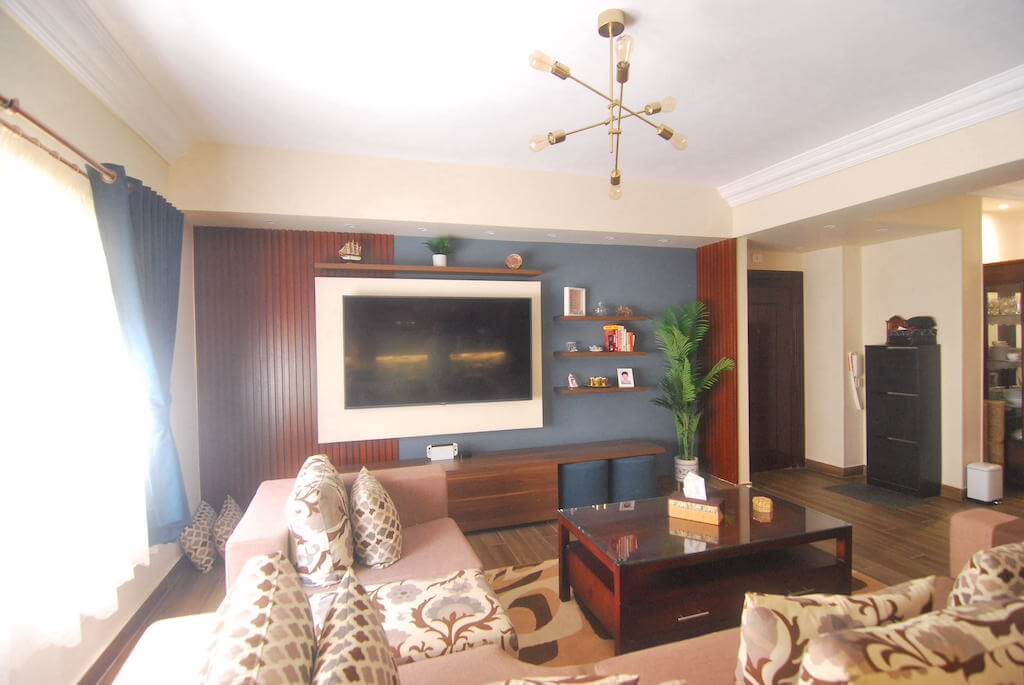 Cozy living room with warm wood tones and layered textures in N Teseen flat renovation