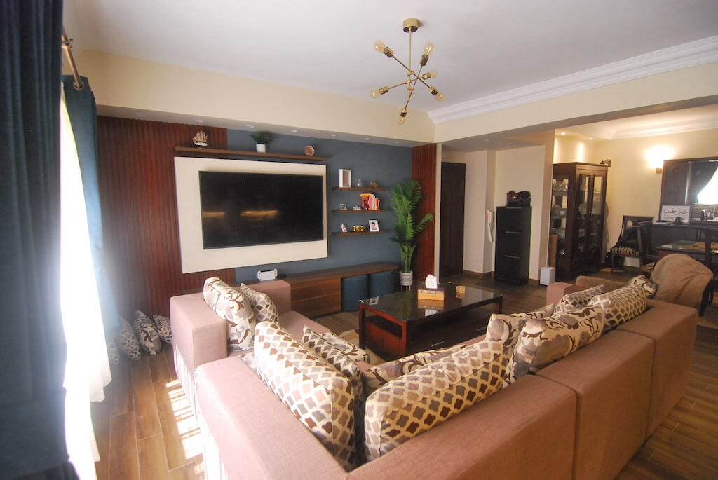 Cozy living room with warm wood tones and layered textures in N Teseen flat renovation