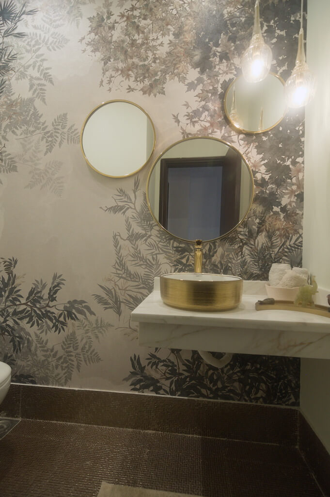 Contemporary guest bathroom with colorful wallpaper and clean finishes in Cairo duplex renovation