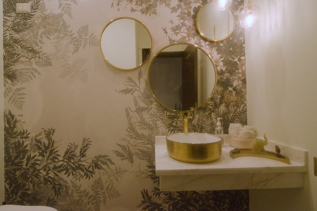 Contemporary guest bathroom with colorful wallpaper and clean finishes in Cairo duplex renovation
