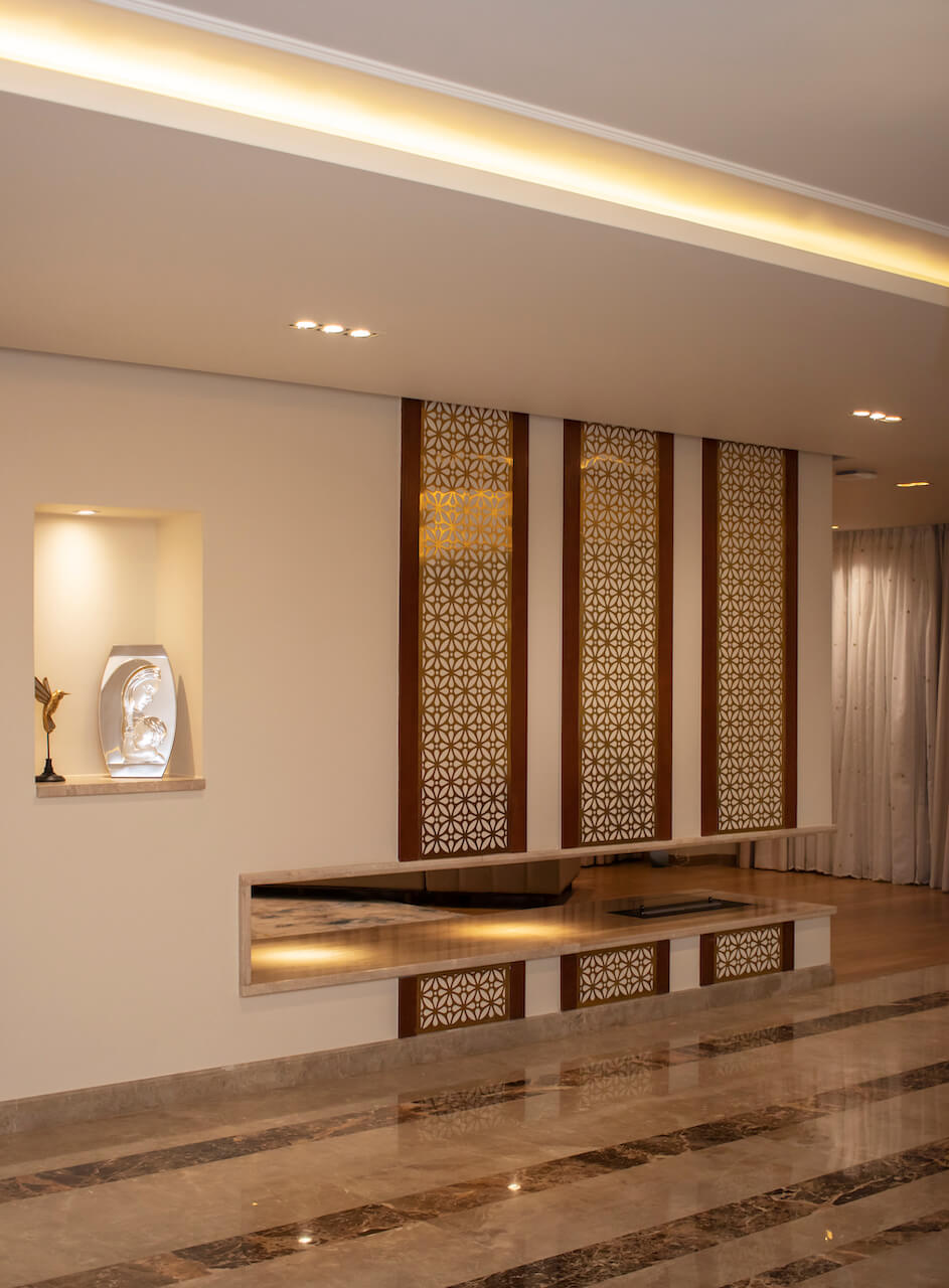 Custom-built partition with integrated fireplace and textured finishes in luxury Heliopolis flat design and build