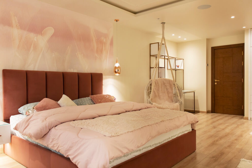 Master bedroom featuring layered lighting, soft wall finishes, and smart climate control in a turnkey interior