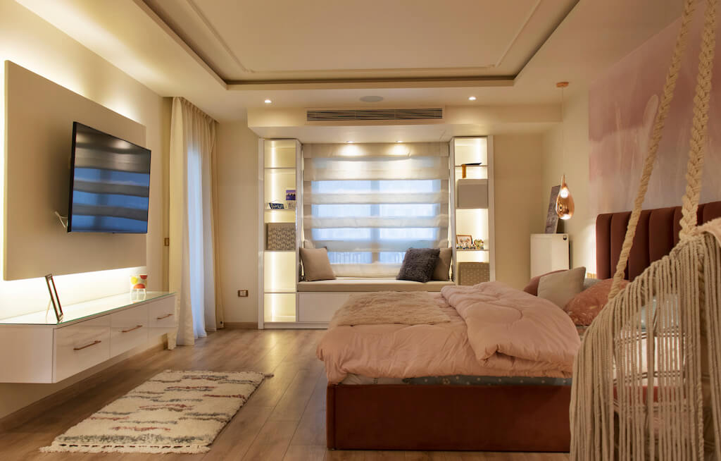 Master bedroom featuring layered lighting, soft wall finishes, and smart climate control in a turnkey interior