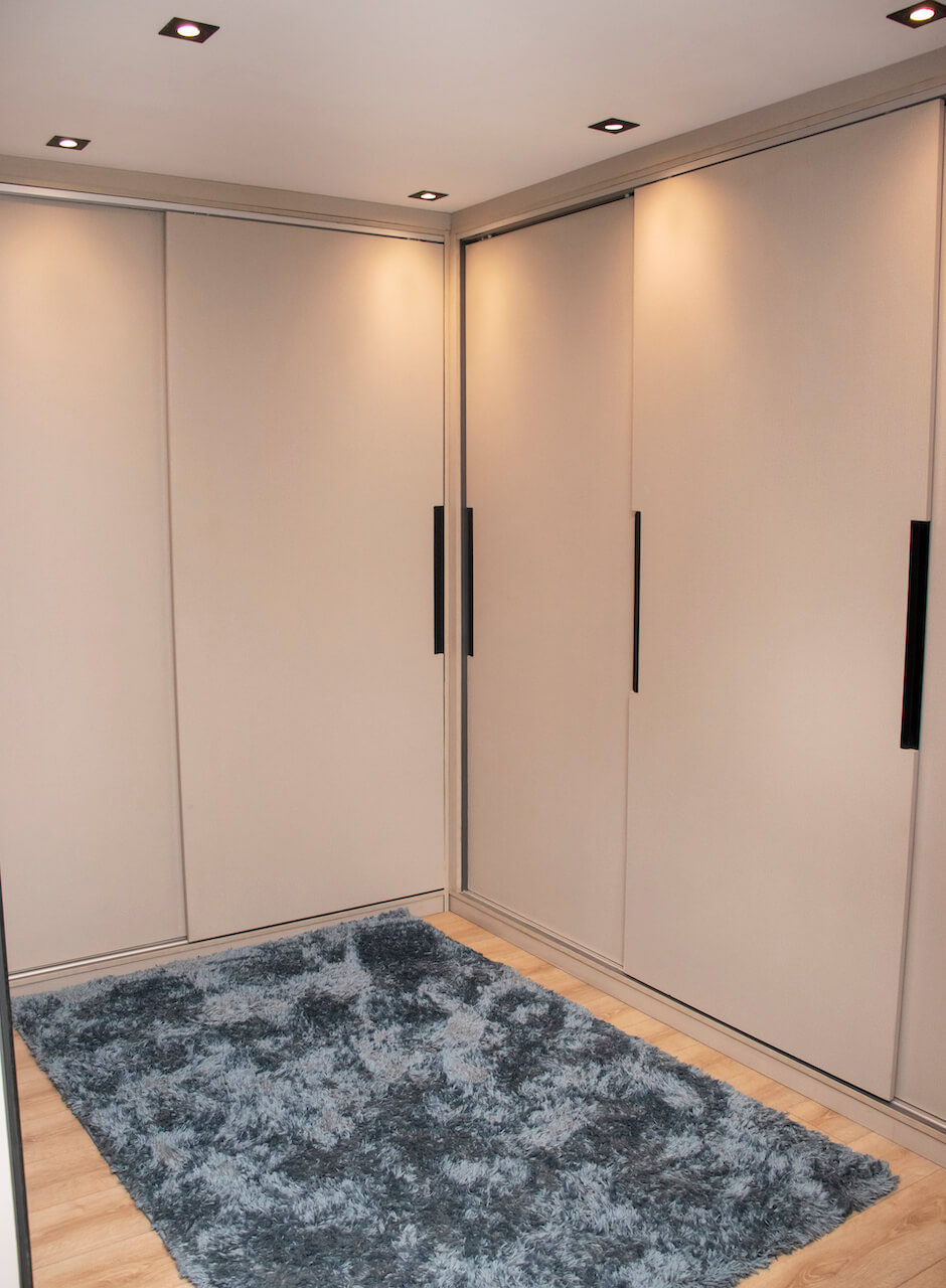 Modern bedroom with black and grey palette, smart lighting, and integrated wardrobe in Heliopolis interior project