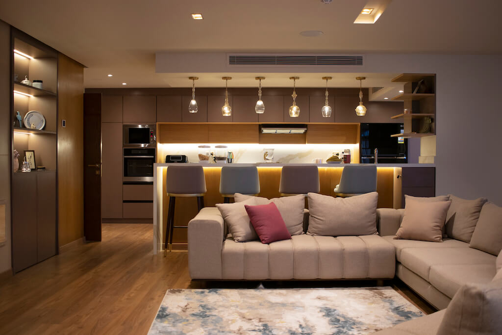 Modern living room with open kitchen, and custom furniture in a turnkey Heliopolis flat