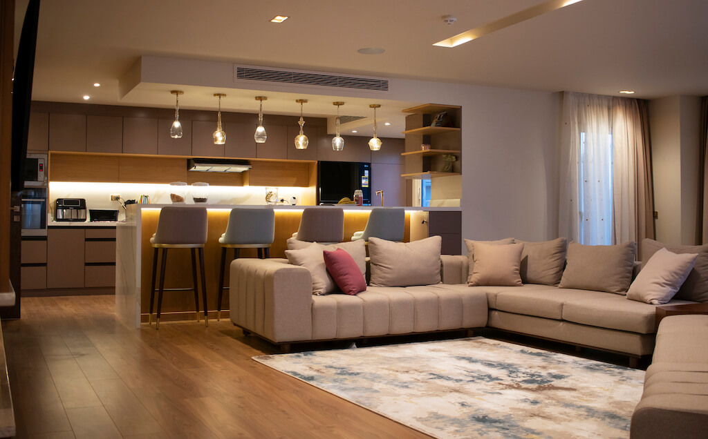 Modern living room with open kitchen, and custom furniture in a turnkey Heliopolis flat