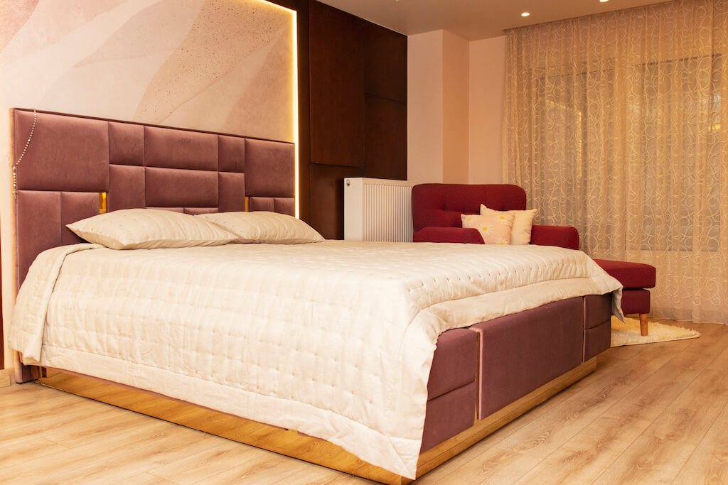 Master bedroom featuring ornate ceiling lighting, soft wall finishes, and smart climate control in a turnkey interior