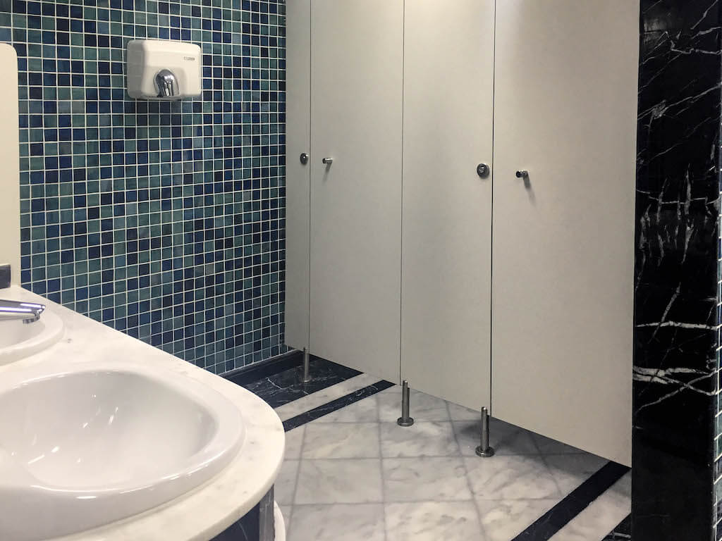 Upgraded gym bathroom with clean finishes and durable materials in office building renovation project