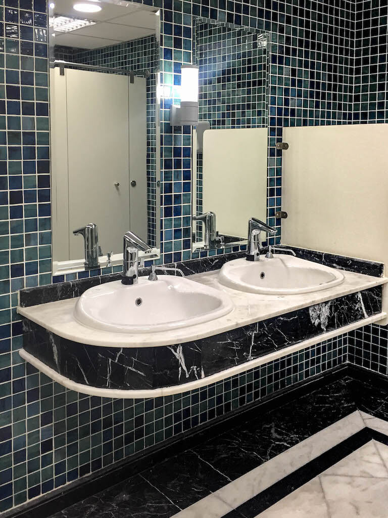 Upgraded gym bathroom with clean finishes and durable materials in office building renovation project
