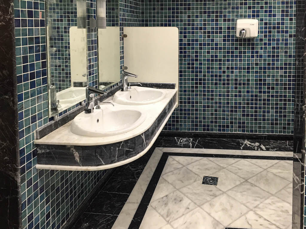 Upgraded gym bathroom with clean finishes and durable materials in office building renovation project