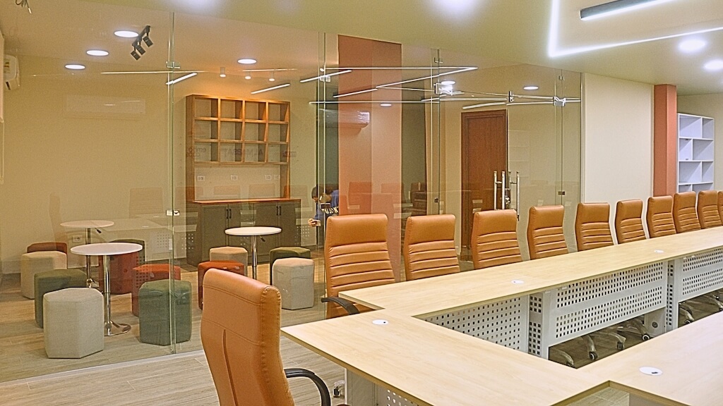 Full training room and coffee area layout in renovated 5th Settlement basement space