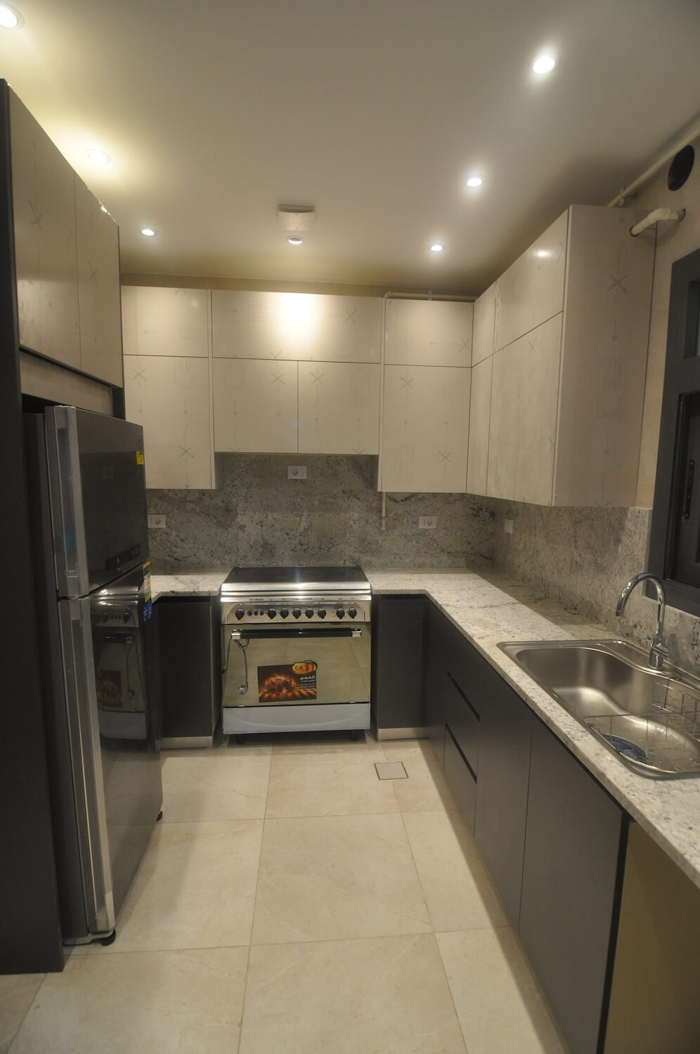 Modern kitchen layout with soft wood textures and integrated appliances in Eastown home