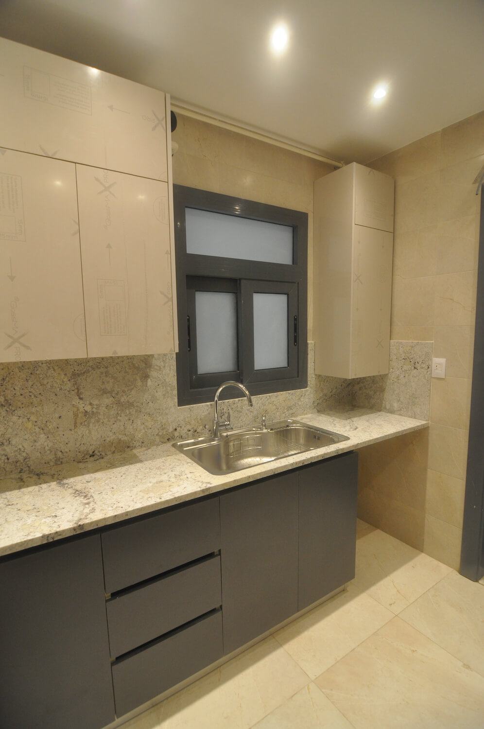 Modern kitchen layout with soft wood textures and integrated appliances in Eastown home