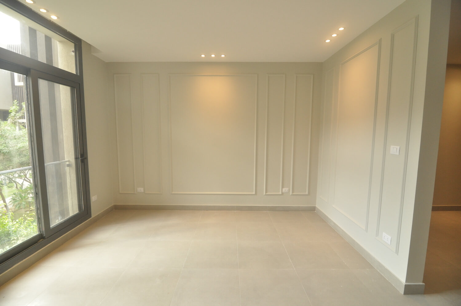 Modern living room with open layout, neutral tones, and custom furnishings in Sodic Eastown new build